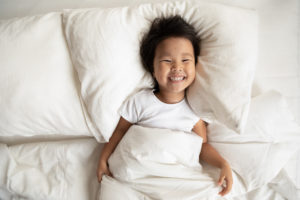 Little Girl on Cozy Bed