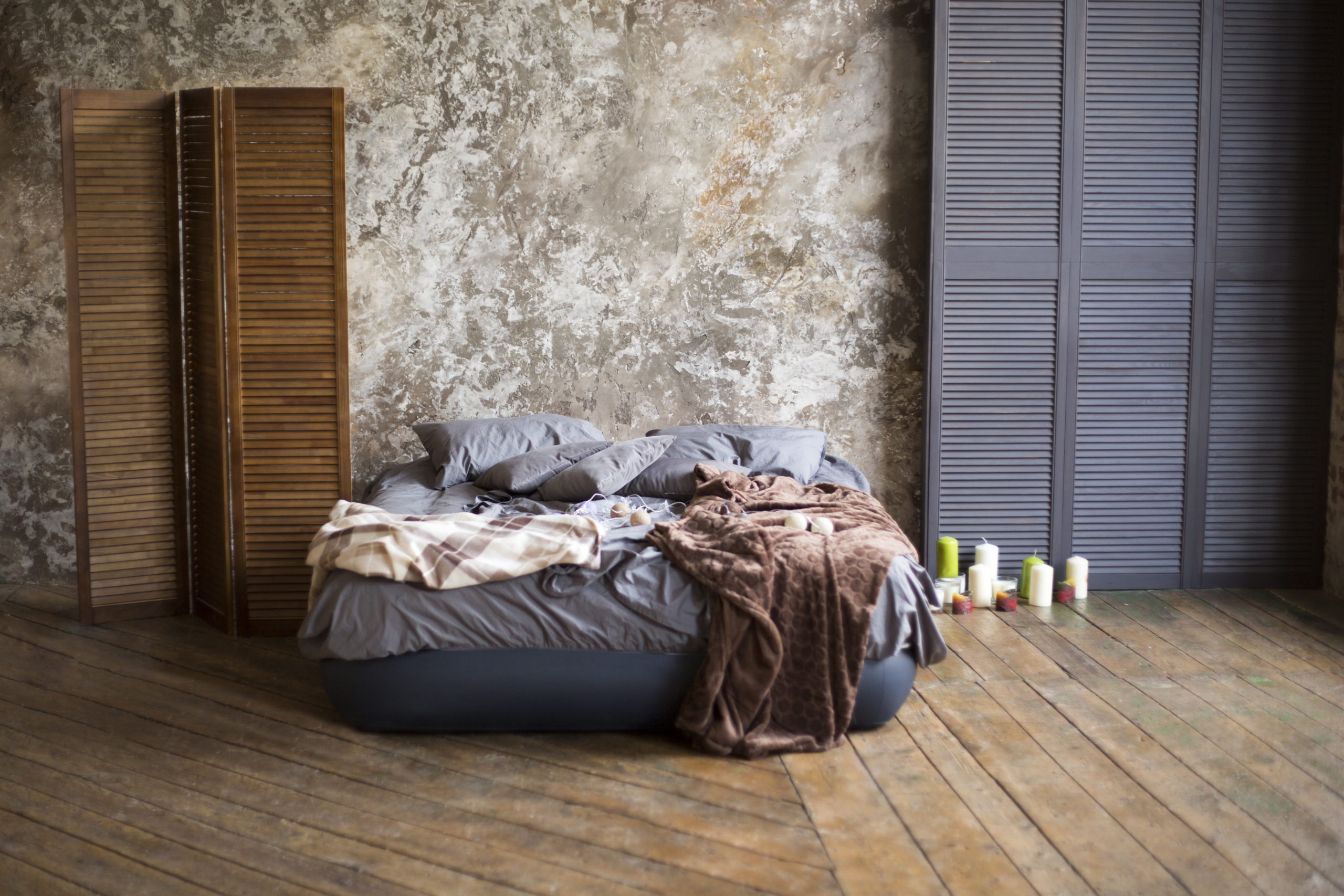Room With a Gray Bed on a Wooden Floor